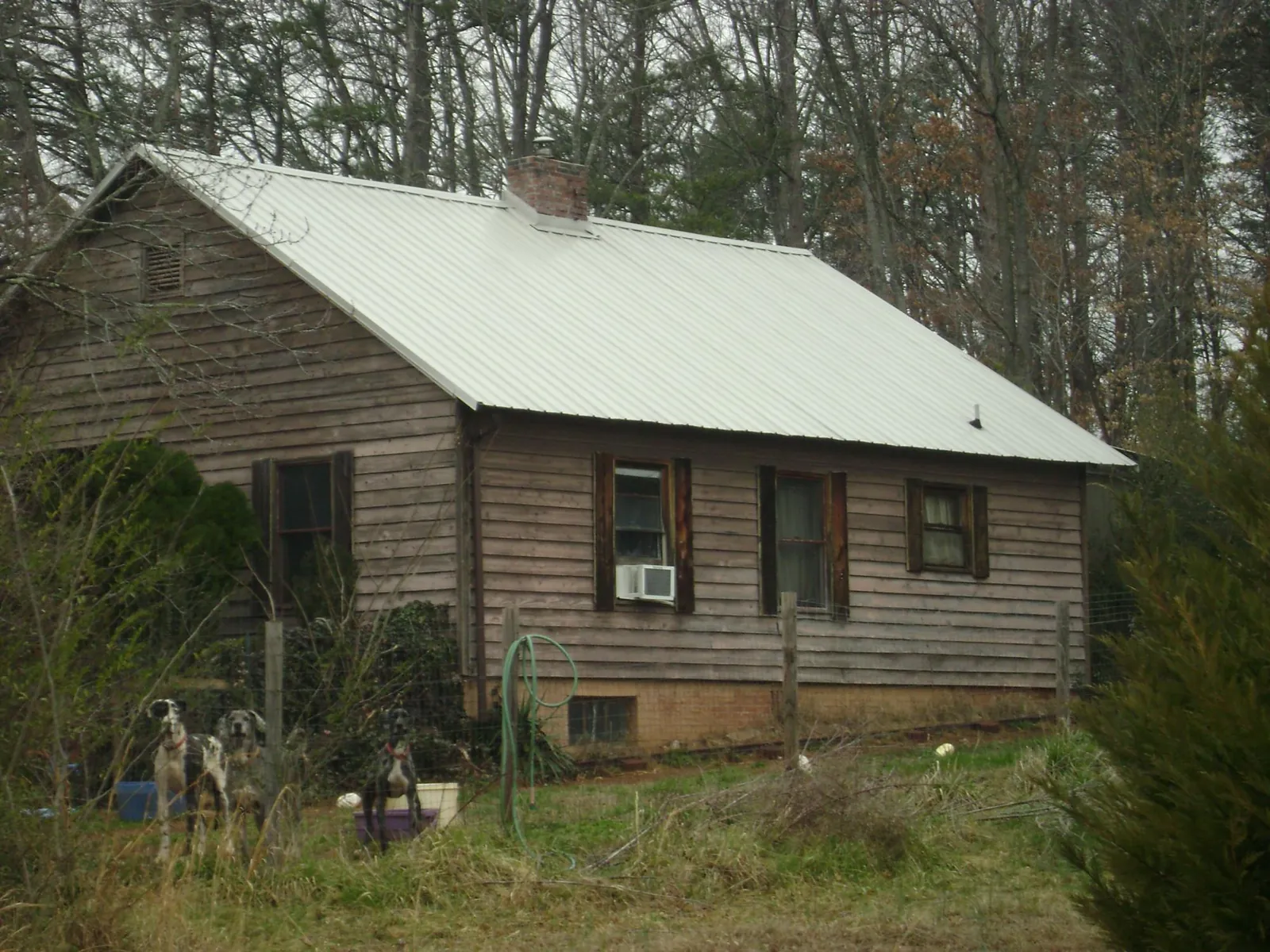 White metal roof on an old wood sided farmhouse, from a Metal Roof Installation job in Pelham